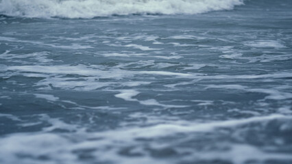 Naklejka na ściany i meble Ocean wave foam splashing in abstract nature background. Blue sea water view.