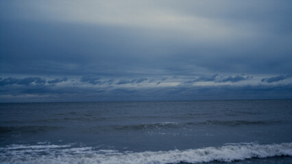 Naklejka na ściany i meble Dark sea landscape background on stormy weather. Blue nature scene on ocean view