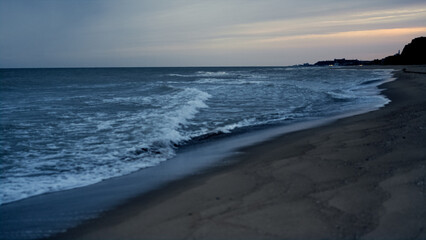 Fototapeta na wymiar Sunset sea waves crashing beautiful sand beach. Majestic dusk on ocean landscape