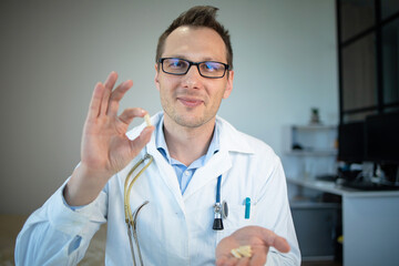 hand of a hospital medical expert shows the pill to be taken to his patient. concept of generical pills
