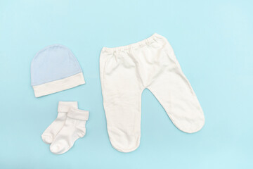 Cute baby white trousers,bodysuit,hat, socks. Set of kids,childrens clothes and accessories in blue color. newborn,infant fashion, outfit. Flat lay, top view