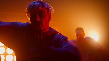 Group breakdancers performing dance in club closeup. B-boy enjoying street style