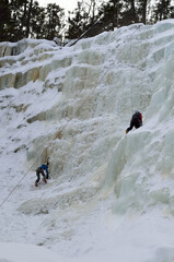Ice climbers on frozen waterfall