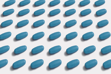 Ordered pattern of blue tablets on white background - 503174884