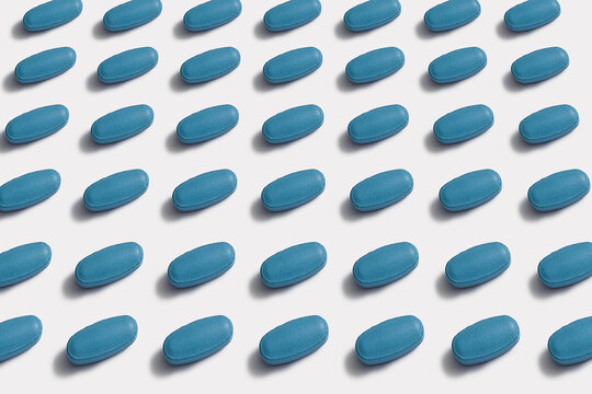 Ordered pattern of blue tablets on white background