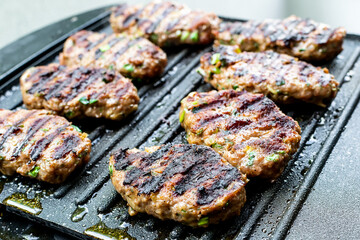Juicy lamb meatballs on teflon barbecue grill