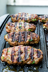 Juicy lamb meatballs on teflon barbecue grill