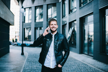 Fototapeta premium Male talking on cellphone on street