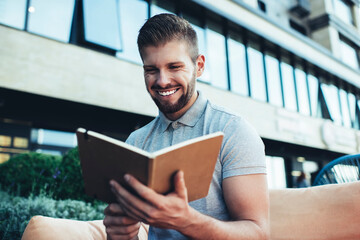 Positive man with opened planner in cafe