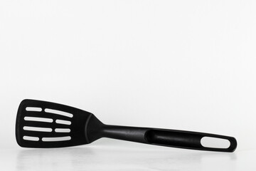 Black spatula for nonstick pan cooking with copy space 
