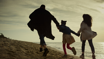 People walk beach happily. Family having fun on sea holiday together outdoors.