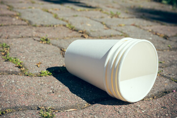 an empty paper cup on a street