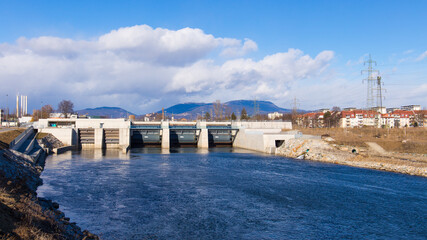 View of the hydro-electric power plant Puntigam in Graz, Austria at the river Mur on a stormy...
