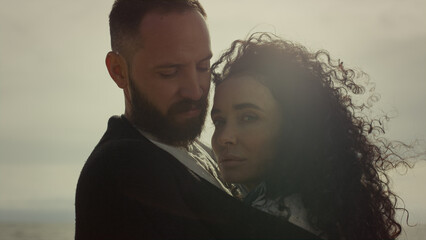 Couple embracing sea beach. Relaxed people enjoy sunny day together outdoors.