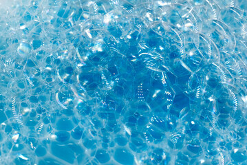 Soap foam. Background of dusty foam with bubbles of blue color for an inscription. Soap sud with copy-space