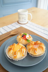 A blue plate of fruit buns on the table -squishy
