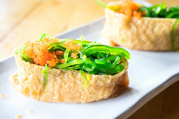 Fried tofu stuffed with rice with wakame and Ebiko