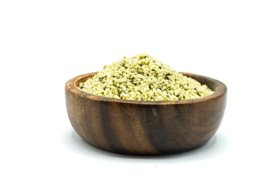 Hemp seeds in wooden bowl isolated on white background