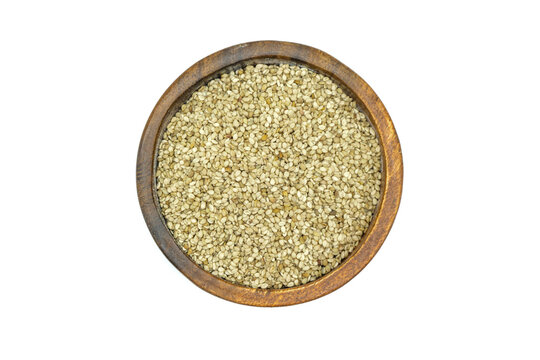 Sesame seeds in wooden bowl isolated on white background top view