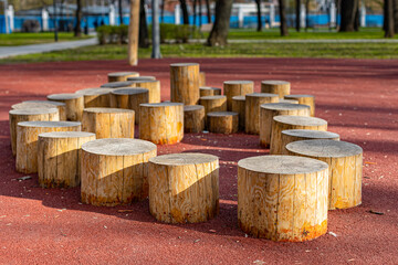 wooden stumps for walking on the playground - obrazy, fototapety, plakaty