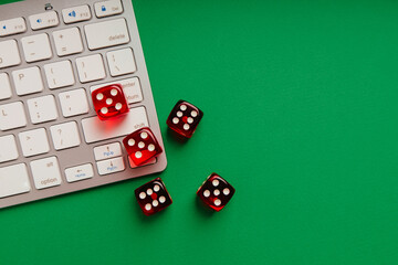 Online casino concept. Five red dice on keyboard
