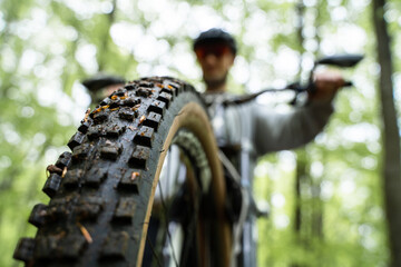 Front tire closeup - Young caucasic man riding a bike, enduro downhill mtb © Bernat