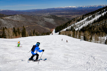 Enjoying skiing downhill at Park City Canyons Ski Area in Utah. Late spring weather conditions....