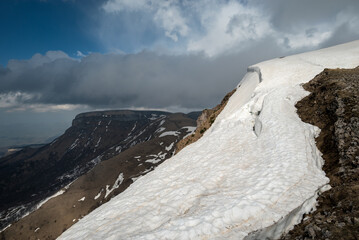 snow-covered slope in the mountains and beautiful clouds