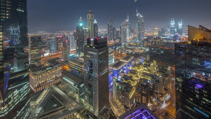 Fototapeta premium Panorama of futuristic skyscrapers after sunset in financial district business center in Dubai day to night timelapse