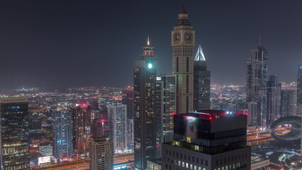 Skyscrapers on Sheikh Zayed Road and DIFC night timelapse in Dubai, UAE.