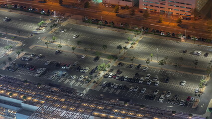 Big parking lot near mall crowded by many cars timelapse aerial view