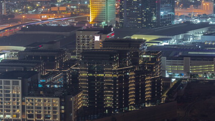 Hotels and office buildings in financial district in Dubai aerial night timelapse