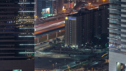 Fototapeta na wymiar Busy Sheikh Zayed Road traffic aerial night timelapse in Dubai city, United Arab Emirates