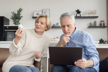 Middle aged couple choosing medication at online shop