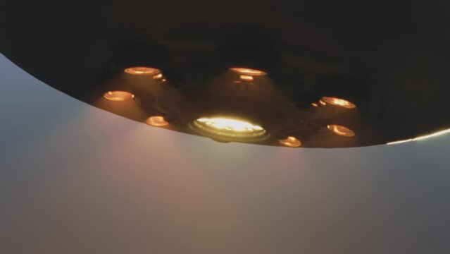 UFO spaceship with glowing lights flying towards the viewer. Alien abduction. Video transition.