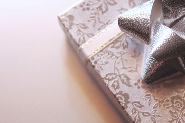 silver gift box and silver ribbon on white background