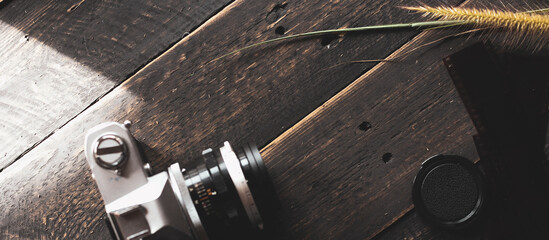 Negative film on a black wooden table and 2 vintage film cameras.