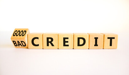 Good or bad credit symbol. Turned wooden cubes and changed concept words Bad credit to Good credit. Beautiful white table white background, copy space. Business good or bad credit concept.