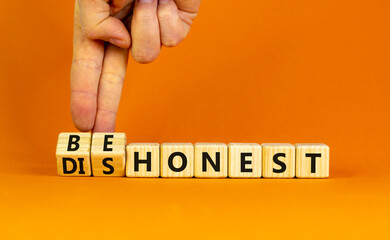 Be honest or dishonest symbol. Businessman turns cubes and changes concept words Dishonest to Be honest. Beautiful orange table orange background. Business be honest or dishonest concept. Copy space.