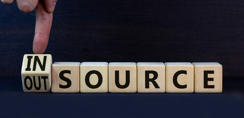 Outsource or insource symbol. Turned a wooden cube and changed the concept word Outsource to...