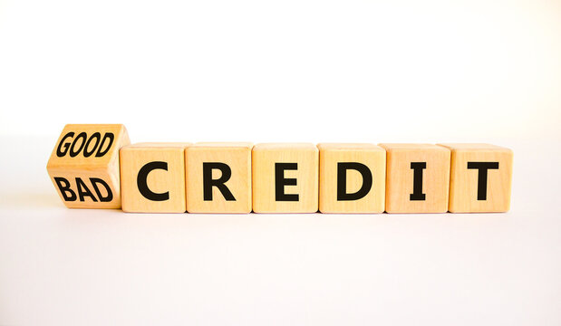 Good or bad credit symbol. Turned wooden cubes and changed concept words Bad credit to Good credit. Beautiful white table white background, copy space. Business good or bad credit concept.