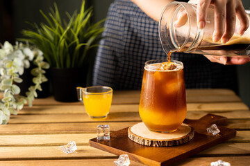 Glass of espresso with orange juice on wooden table and copy space, Summer Cocktail, Cold brew...