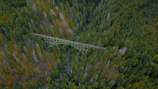 Aerial orbit of abandoned Vance Creek Bridge in the pacific northwest state of Washington.