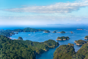 Fototapeta na wymiar Bird's-eye view of the Kujūkushima seascape with islands that lie off sasebo famous for its saw-toothed coast with multiple islets part of Saikai National Park in Kyushu.