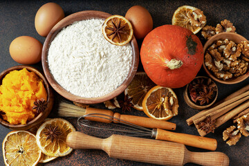 Ingredients for American pumpkin pie, blondie or bars on a dark culinary background. Products for homemade traditional autumn baking top view 