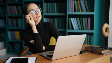 Economist woman glasses on face work stylish office, uses laptop, report to a freelancer company © muse studio