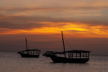 Zanzibar, Tanzania, Sunset on the Indian Ocean with boats.