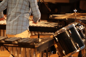 A person playing percussion close-up musical background image of drums selective focus on the keys