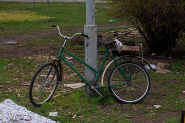 Fototapeta premium An old bicycle abandoned on the street