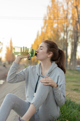 Woman drinking water in the park